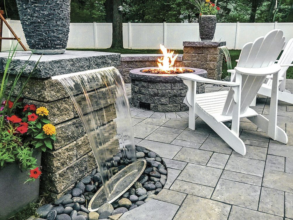 Ideal Concrete Block catalog image of pavers on patio and blocks used for waterfall and fire pit
