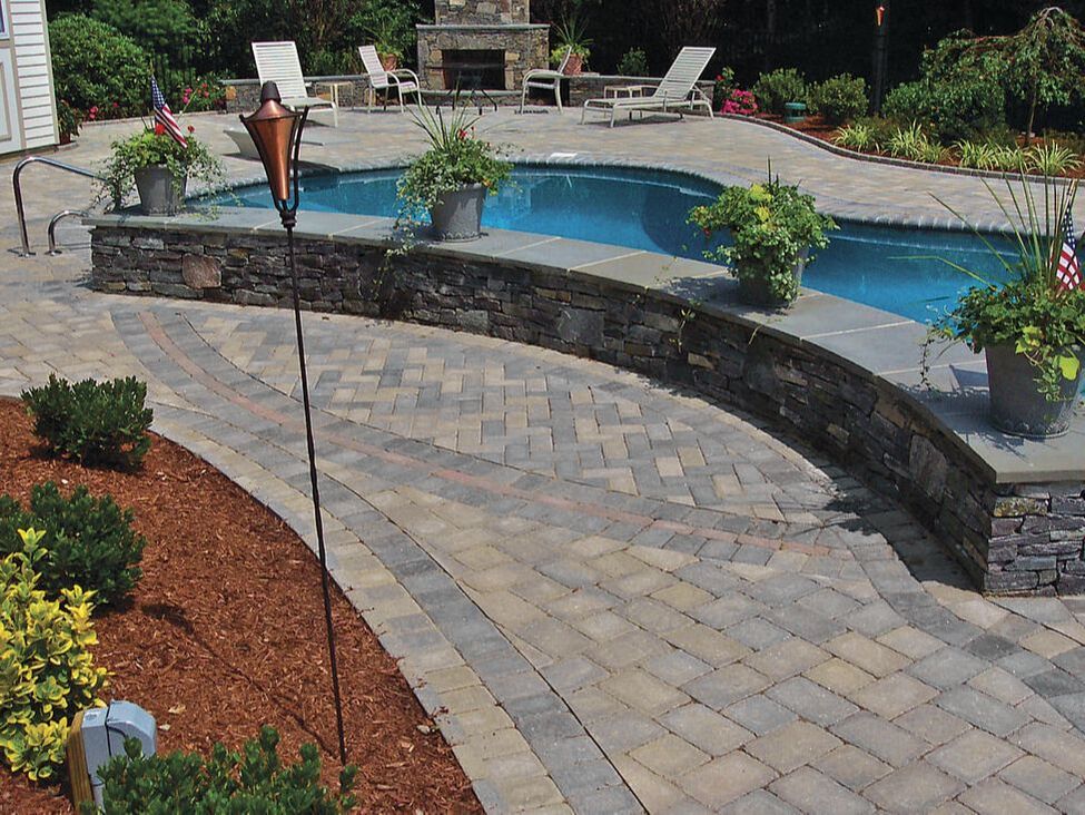 Ideal Concrete Block catalog image of pool side wall and patio with pavers